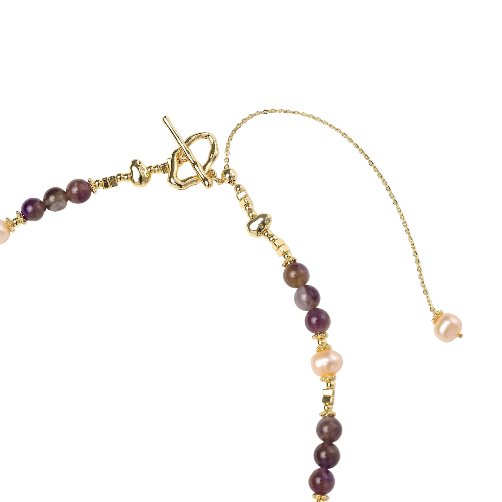 Gold necklace with iridescent baroque pearl pendant, purple amethyst beads, and crystal star charm on cream background