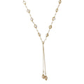 Adjustable gold lariat necklace with freshwater pearls nested in delicate cage settings and Y-shaped tassel drop