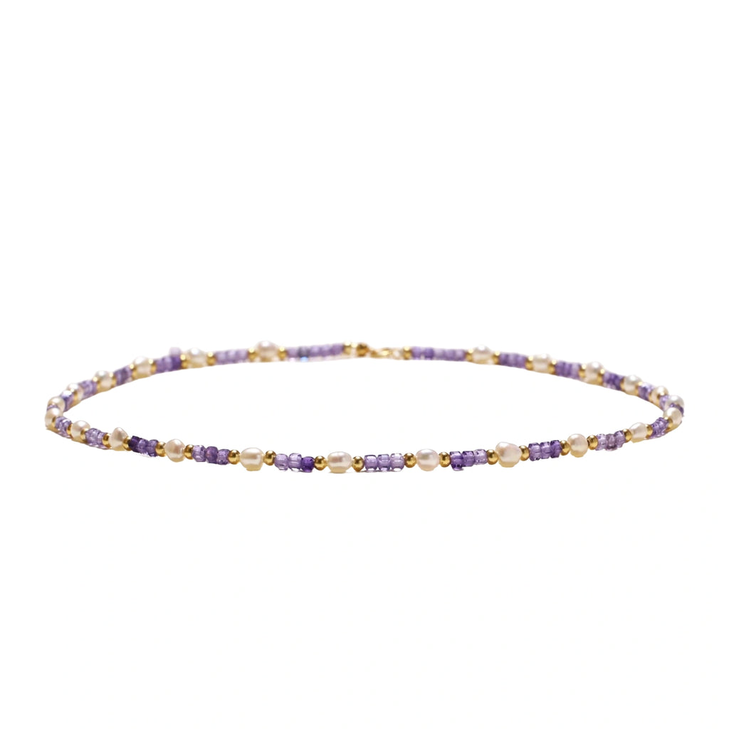 Delicate 18K gold vermeil necklace with alternating lavender zirconia beads and white freshwater pearls on cream background