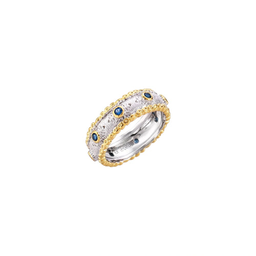 Two-tone ring with brushed silver center, gold beaded edges, and blue zirconia stones on white background.