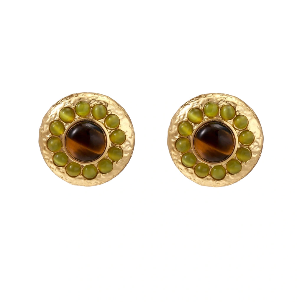 Round hammered gold studs with brown tiger's eye center surrounded by olive green liuli stones on white background.