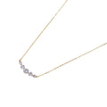 Delicate 14K gold-plated necklace with five graduated zirconia stones arranged in a curved arc on fine chain