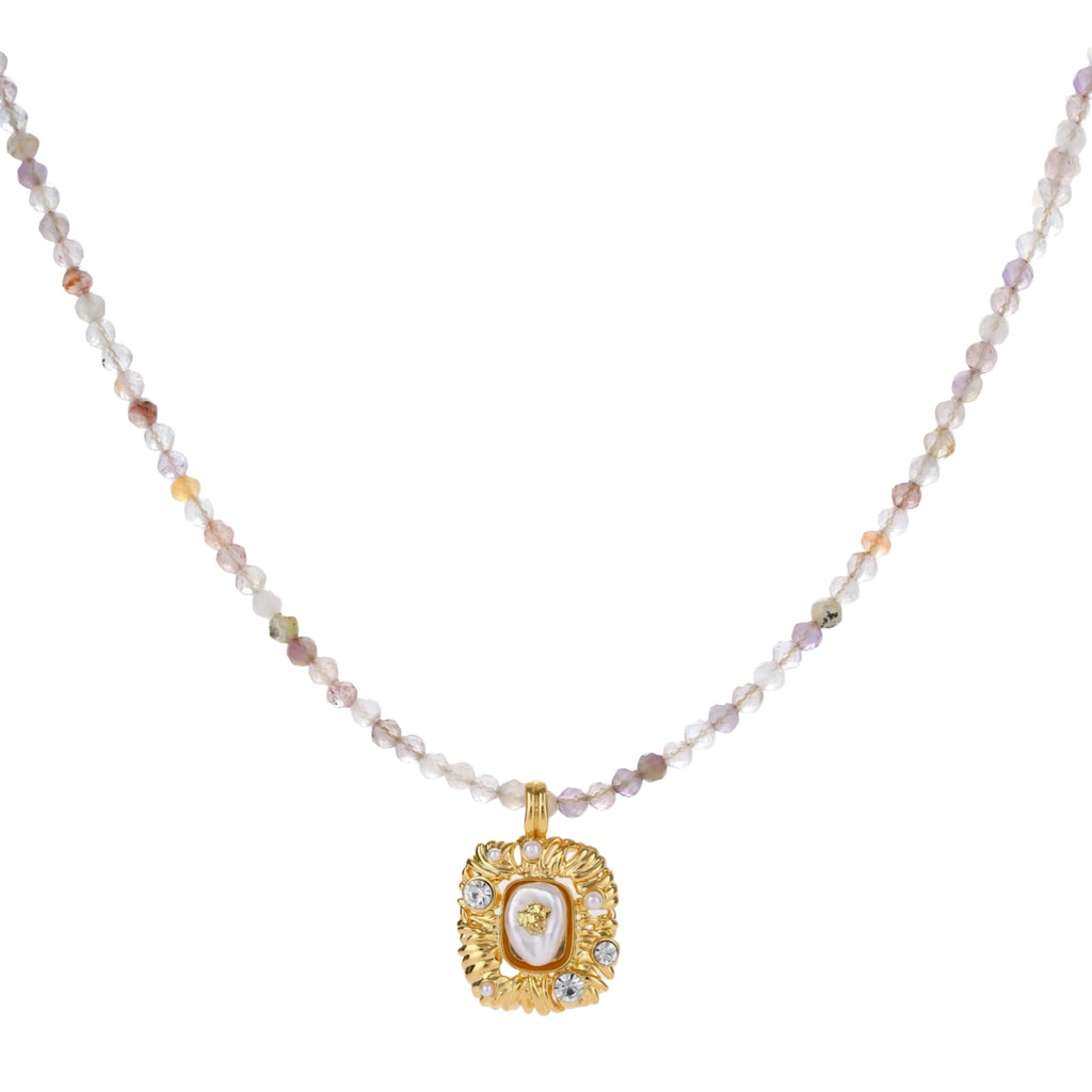 Ornate gold-plated pendant necklace with multicolored gemstone beads in purple, pink and clear tones on white background