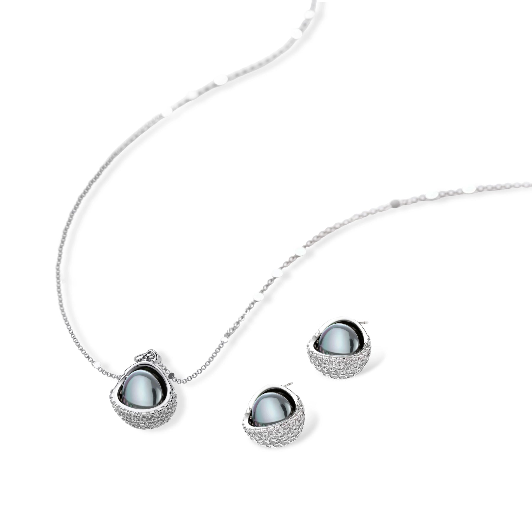 Elegant spherical pendant necklace and earrings set featuring crystal-pavé bottom half in gold or silver finish on white background.