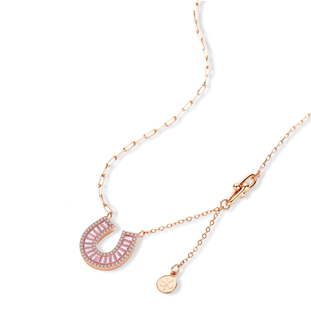 Sparkling horseshoe-shaped jewelry set with AAA cubic zirconia in gold-plated and white gold finishes on cream background.