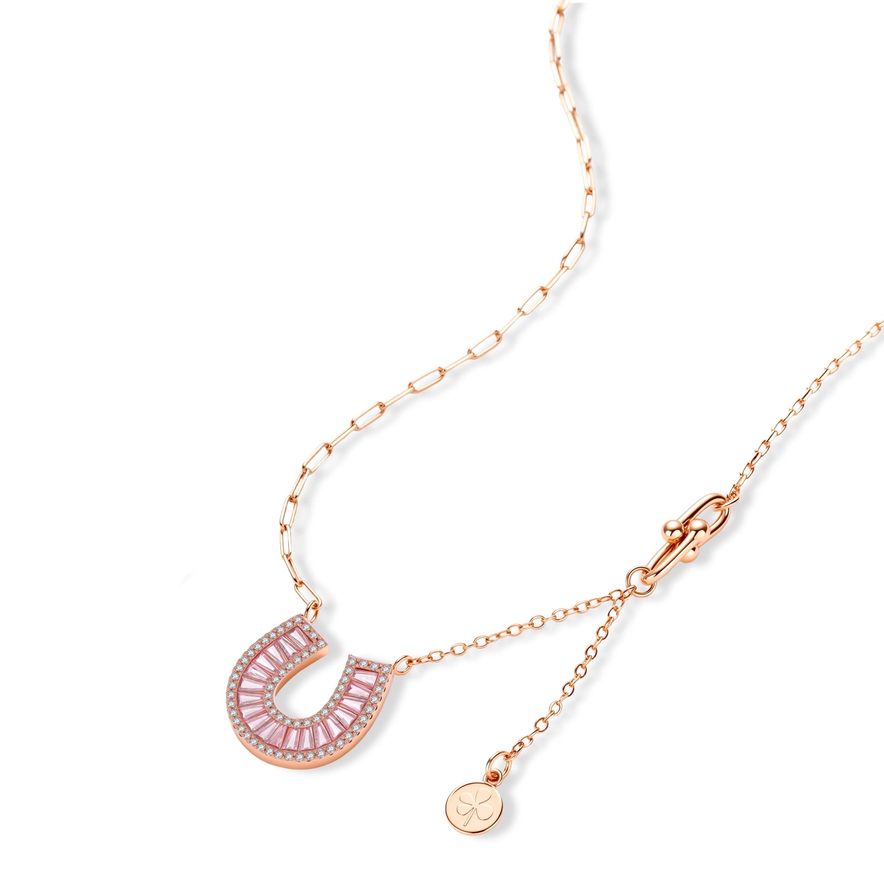 Sparkling horseshoe-shaped jewelry set with AAA cubic zirconia in gold-plated and white gold finishes on cream background.