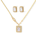 Gold-plated jewelry set with rectangular cubic zirconia stones in pave halo settings on cream background