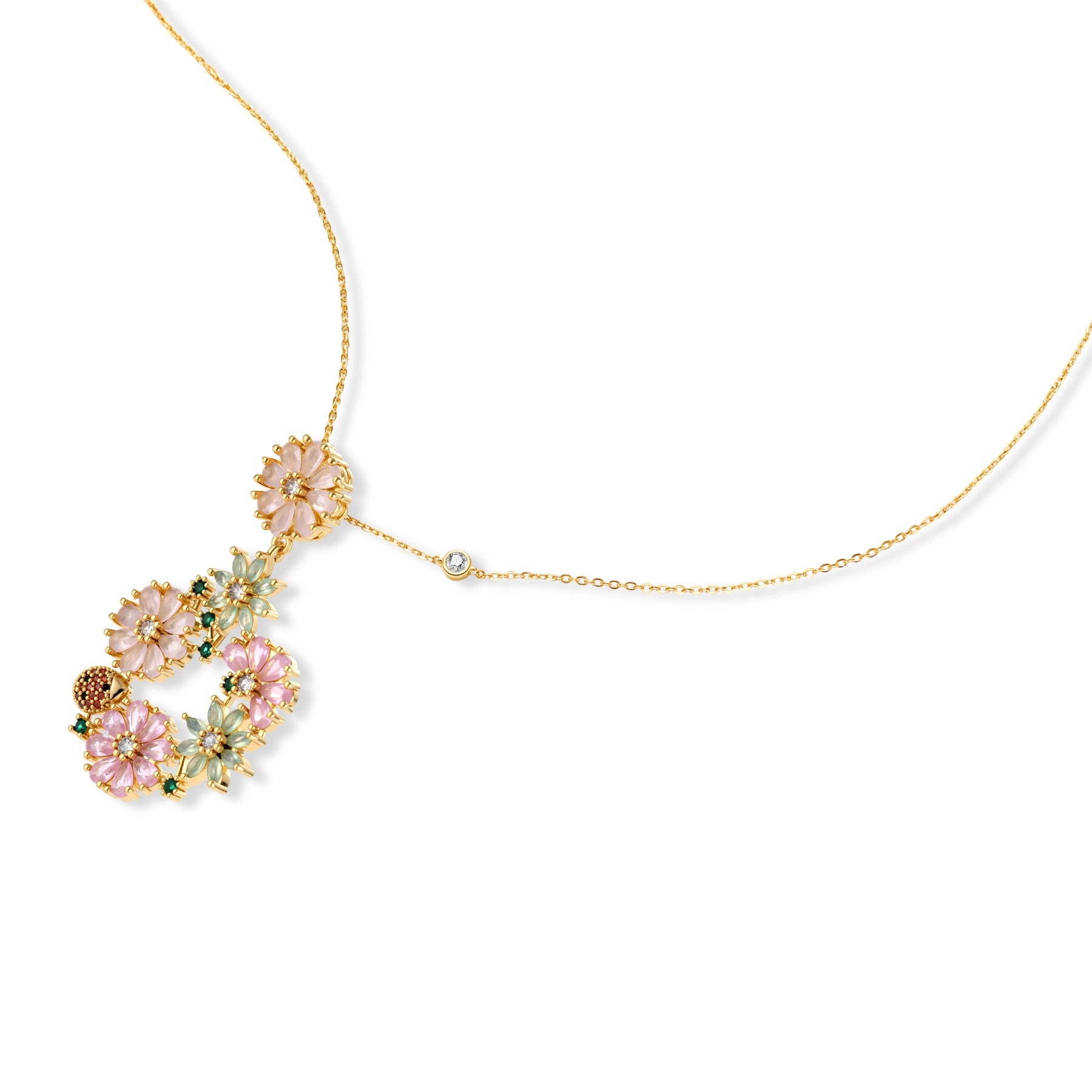 14K gold plated jewelry set with pink and green cubic zirconia flowers arranged in wreath design on cream background